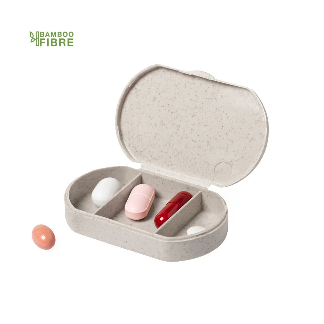 A grey pillbox made from bamboo fibre, with compartments for tablets and two capsules beside it. Varsum Pillbox - Image 1
