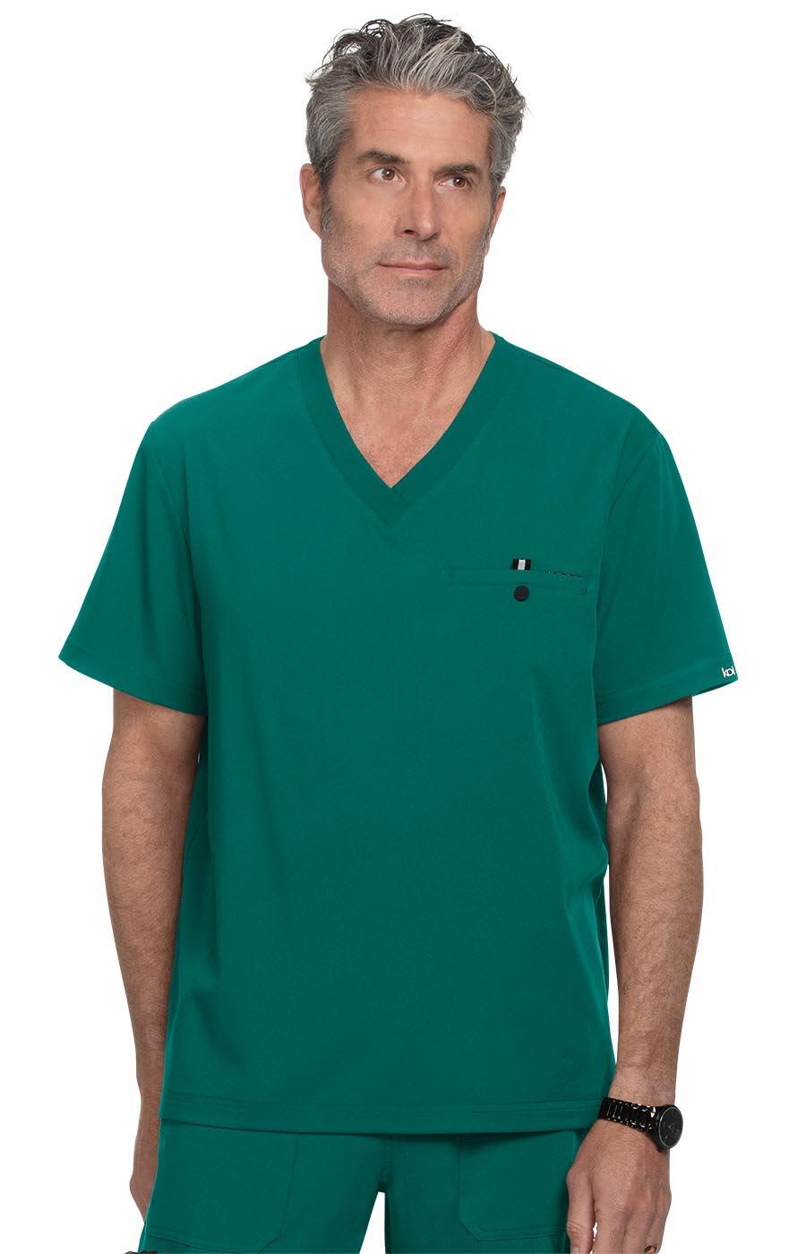 A teal V-neck scrubs top featuring a chest pocket and a logo on the sleeve. The model has grey hair. On Call Top - Image 1