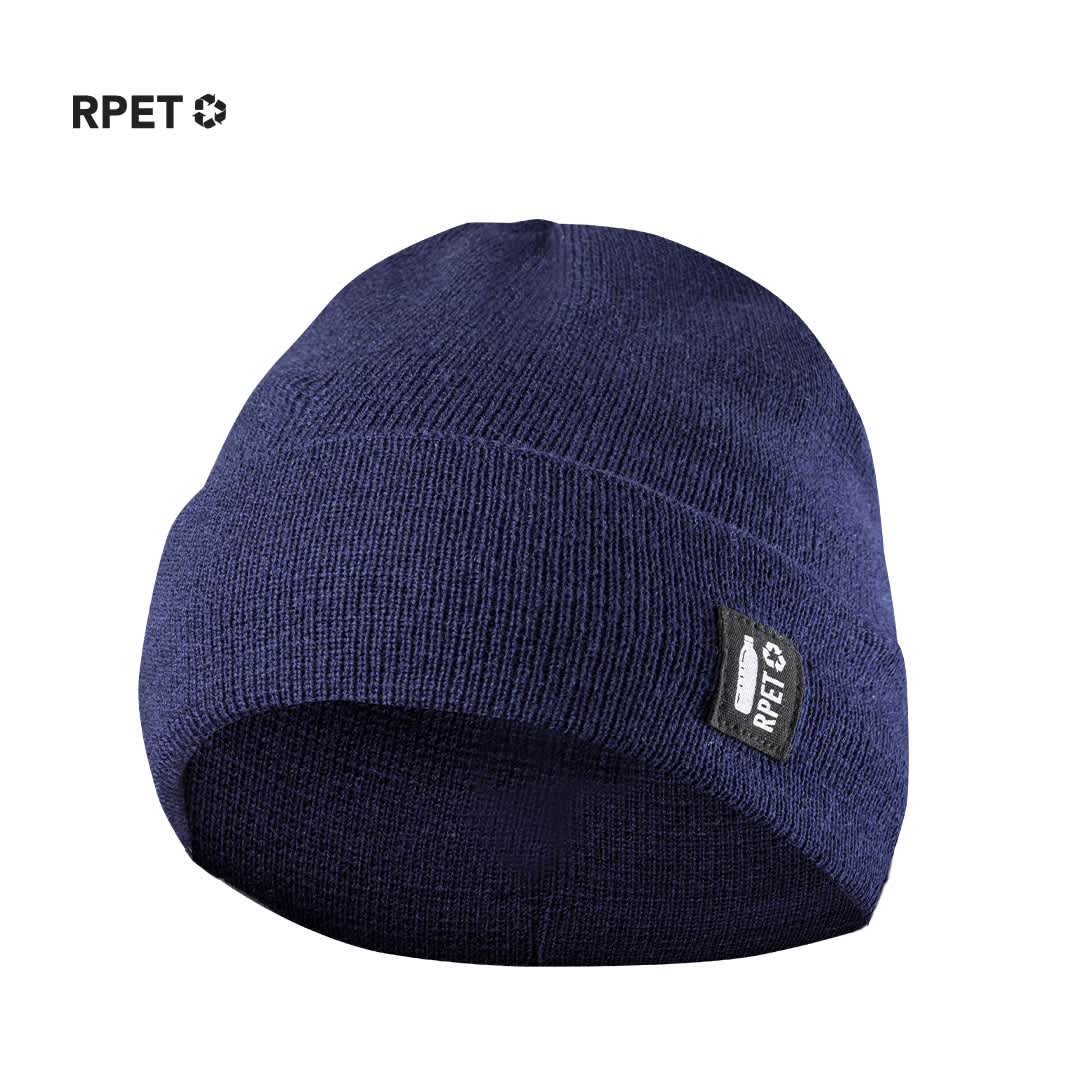 A navy blue beanie made from RPET fabric, featuring a small branding label. Hetul Hat - Image 1
