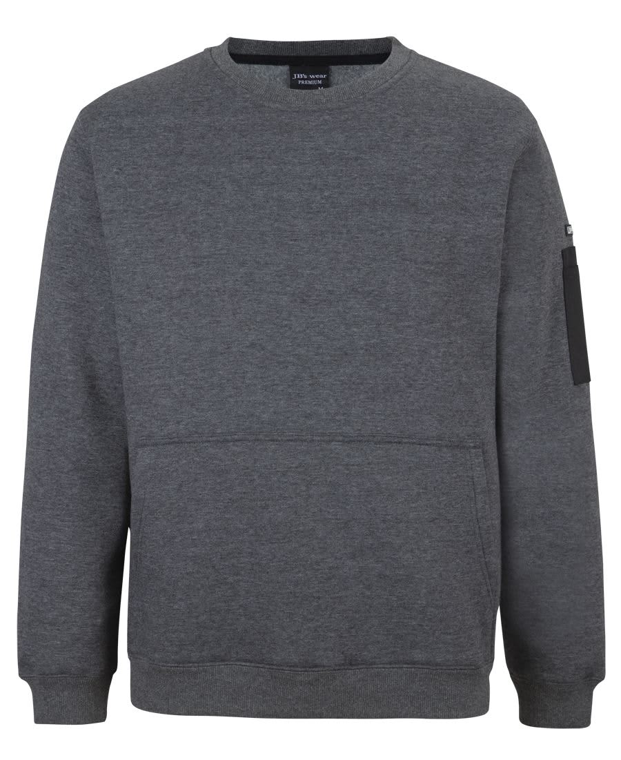 A grey crew neck fleece jumper with a front pocket and a side zipper pocket. It features a logo. JB's 350 Premium Trade Crew Neck Fleece - Image 1