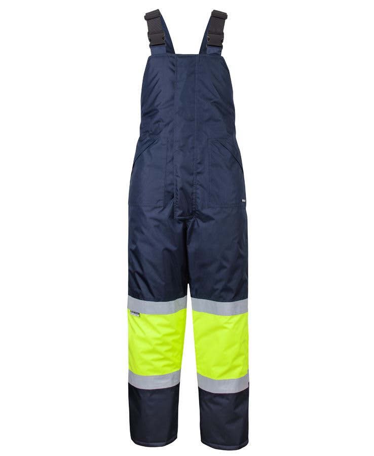 A pair of navy and lime bib and brace overalls with reflective tape, designed for safety wear. JB's Freezer Bib & Brace With Tape - Image 1