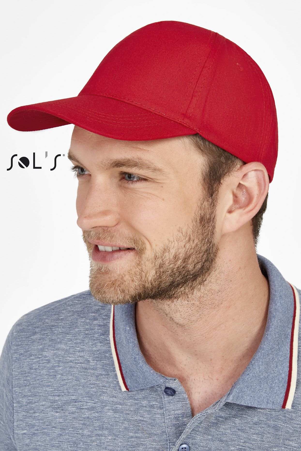 A red five-panel cap worn by a man, featuring a curved brim and a branding logo. CAP BUZZ FIVE PANEL CAP - Image 1