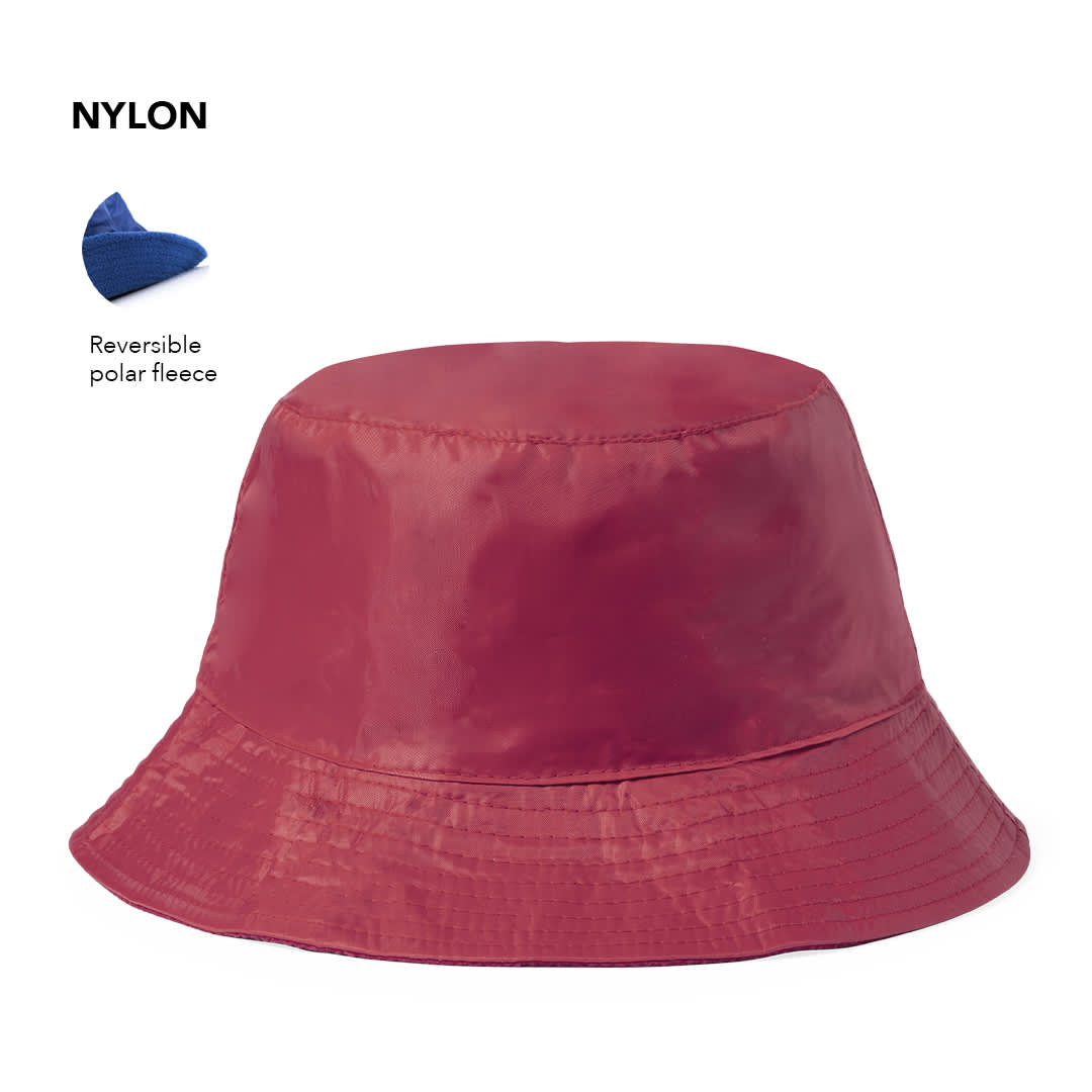 A reversible bucket hat in red nylon, featuring polar fleece on one side and a logo. Nesy Reversible Hat - Image 1