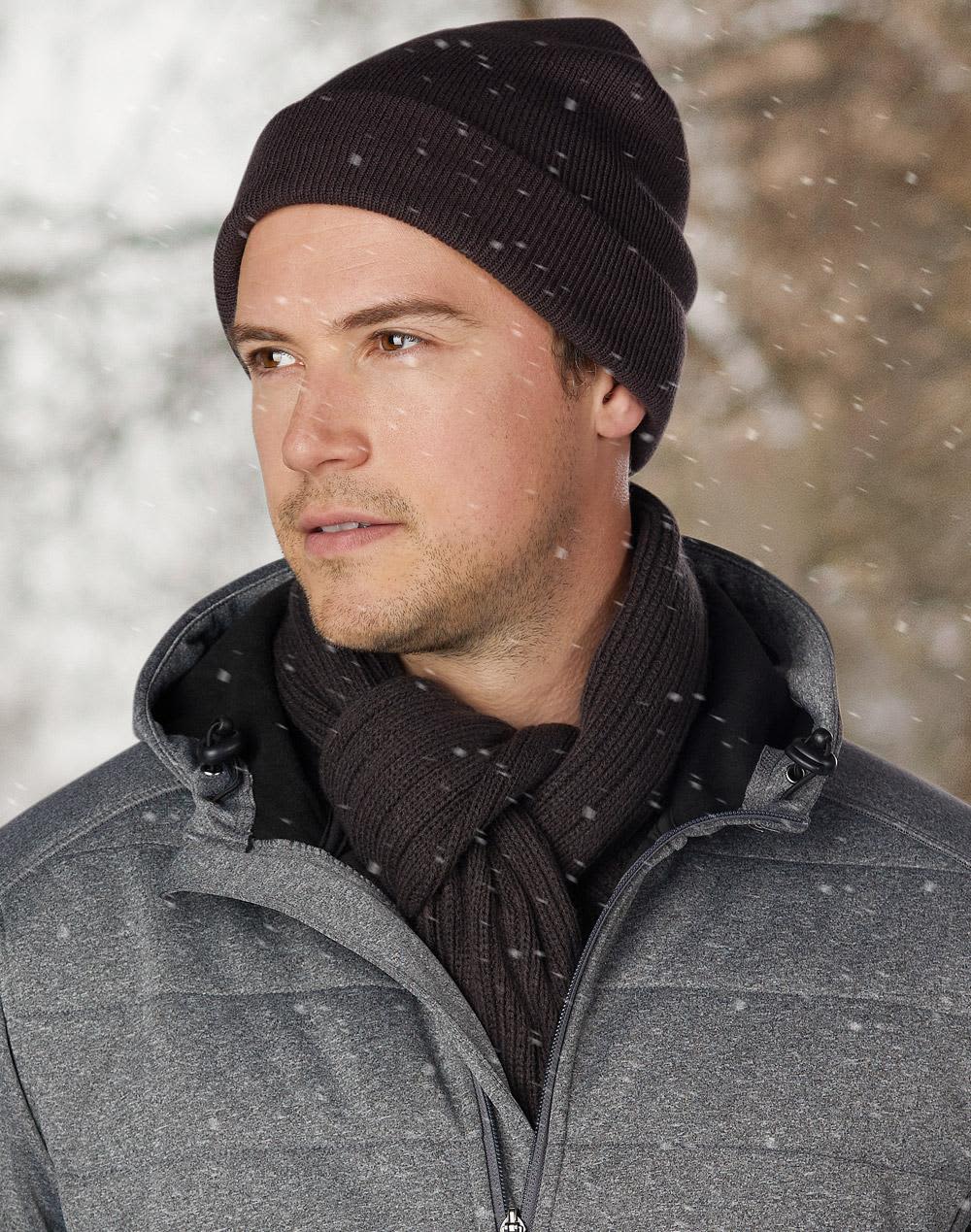 A red acrylic beanie with a ribbed texture and a rolled brim. It features a branding logo. Acrylic Beanie - Image 1
