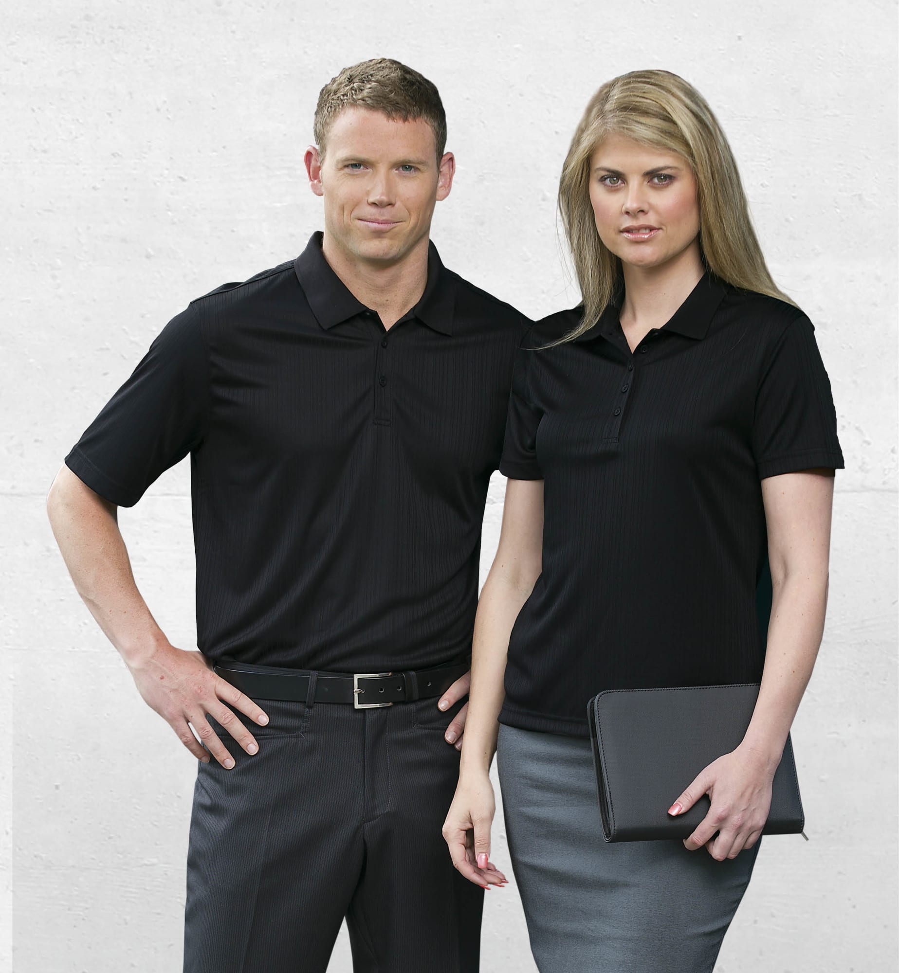 A black Dri Gear Corporate Pinnacle Polo for women, featuring a logo, paired with tailored grey bottoms. Dri Gear Corporate Pinnacle Polo - Womens - Image 1