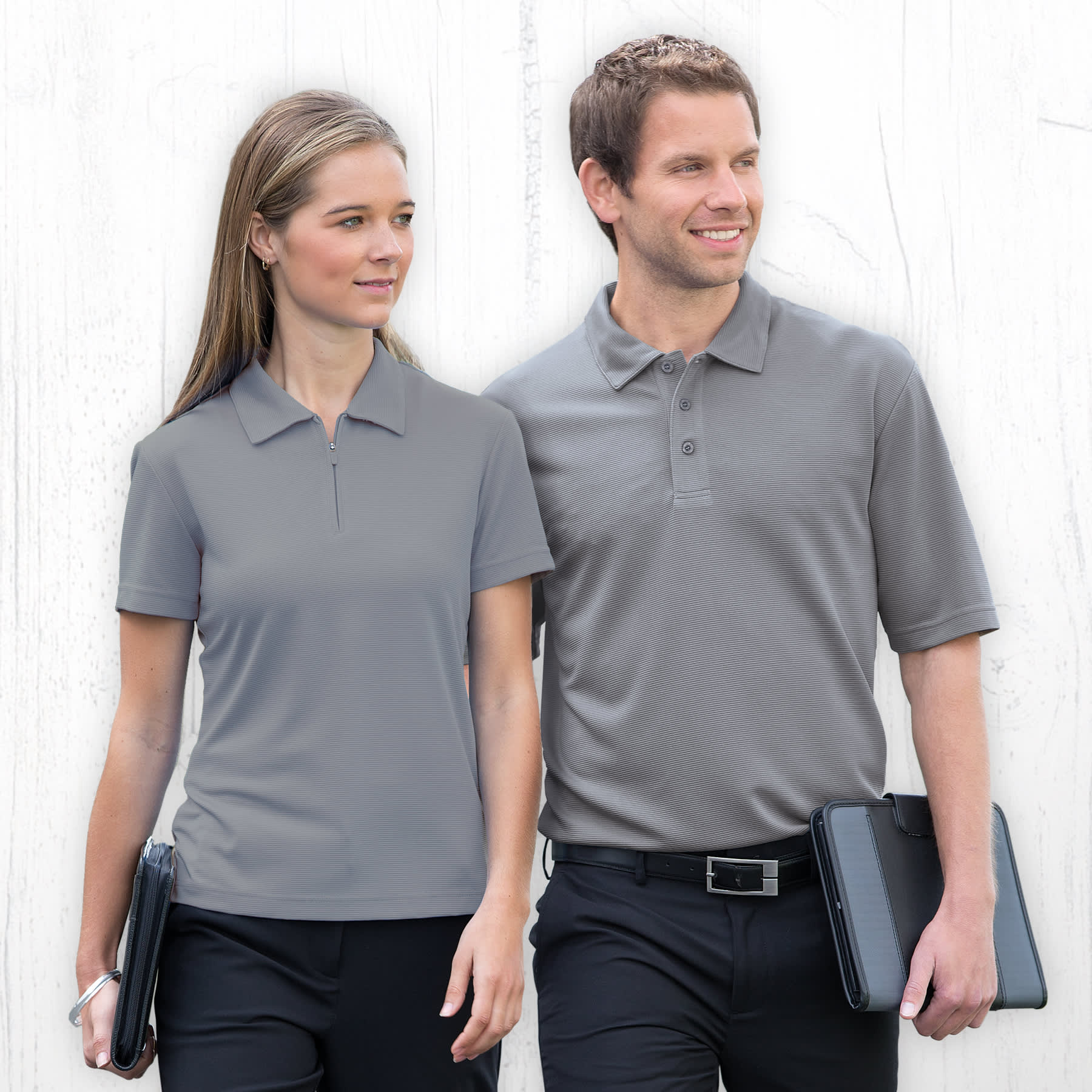 A grey polo shirt for men, featuring a collar and short sleeves, displayed with a male model and a female model. Dri Gear Ottoman Lite Polo - Mens - Image 1