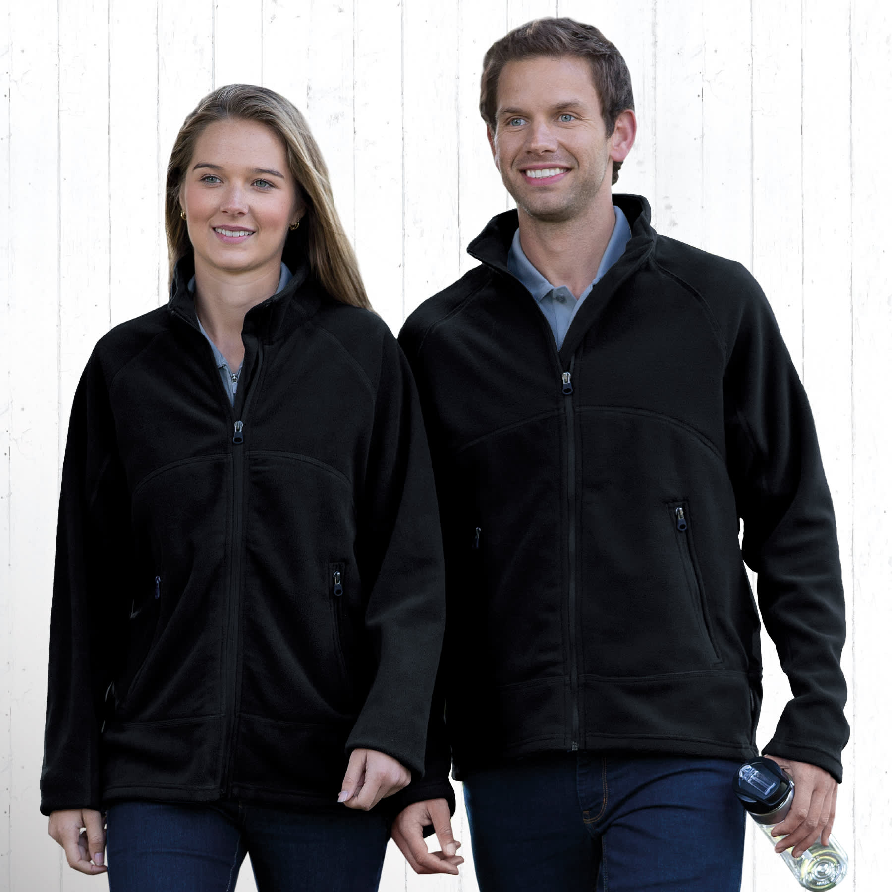 Two people wearing black Explorer Microfleece Jackets, featuring zippered pockets and standing against a neutral background. Explorer Microfleece Jacket - Image 1
