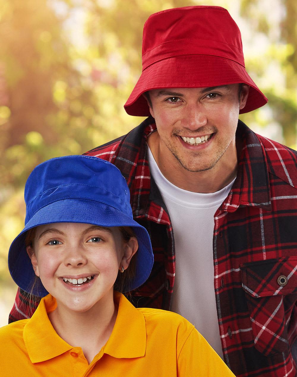A red bucket hat and a blue bucket hat are worn by a smiling man and girl outdoors. Both hats feature a toggle. Bucket hat with toggle - Image 1