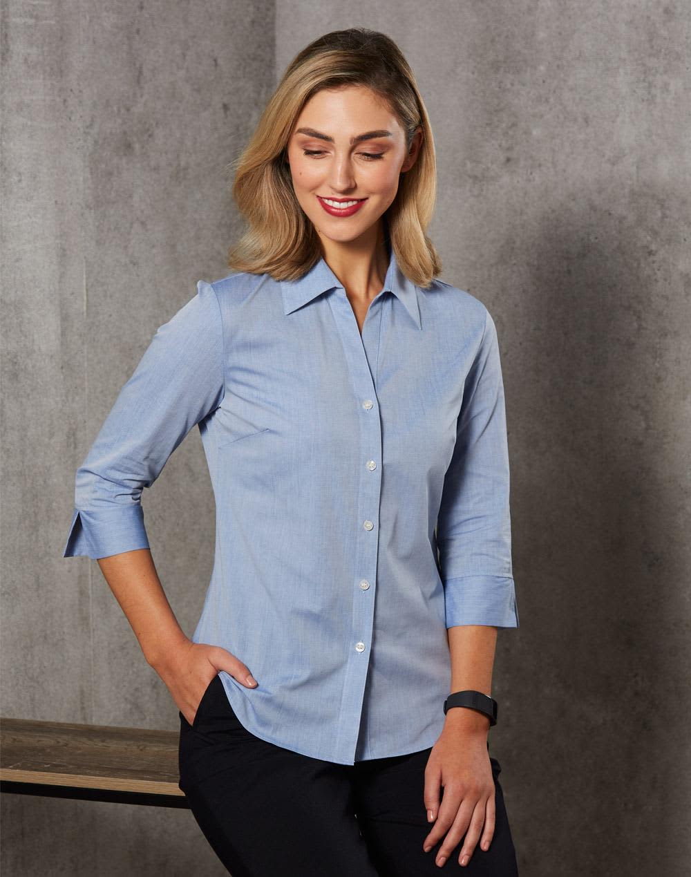 A women's fine chambray shirt in light blue with 3/4 sleeves and a button-up design, featuring a logo. Women's Fine Chambray 3/4 Sleeve Shirt - Image 1