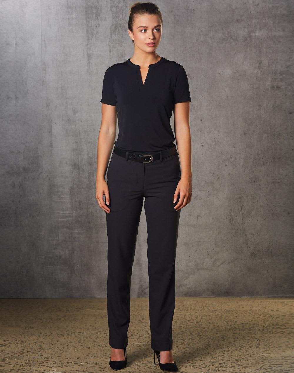 A woman wearing black Women's Flexi Waist Utility Pants, paired with a matching top, standing against a textured background. Women's Flexi Waist Utility Pants in Poly/Viscose Stretch - Image 1