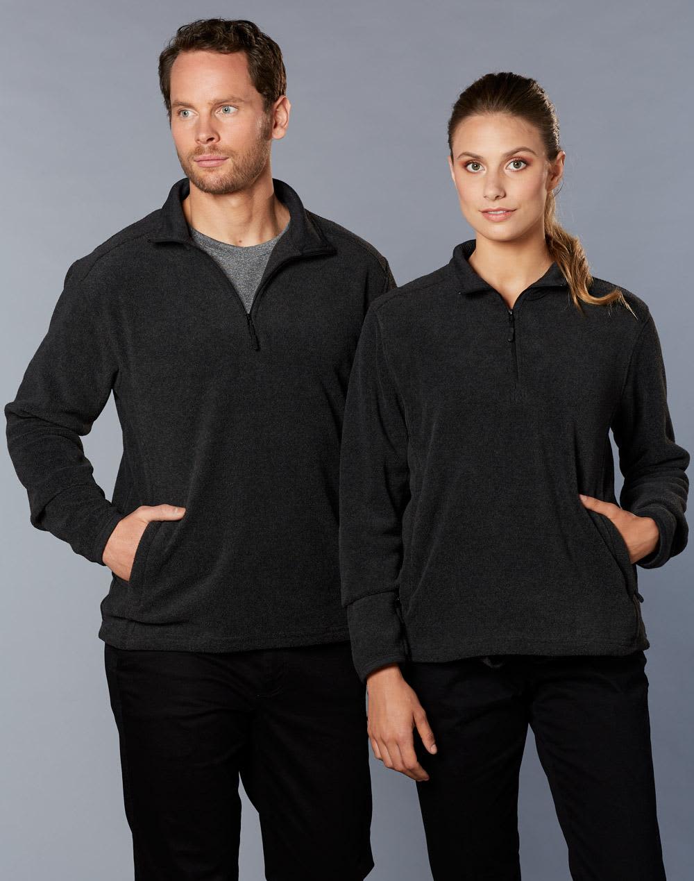 A grey half zip polar fleece pullover on two models, one male and one female, both with pockets and standing side by side. Adult's Half Zip Polar Fleece Pullover - Image 1
