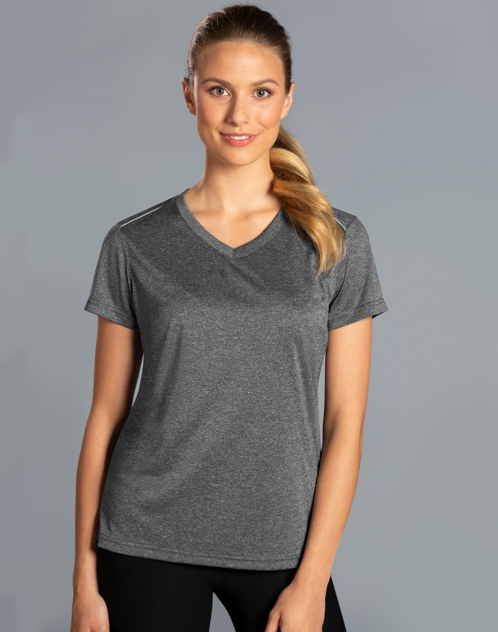 A grey short sleeve tee with a V-neck design, featuring a logo, worn by a smiling woman against a plain background. Ladies' Ultra Dry Cationic Short Sleeve Tee - Image 1