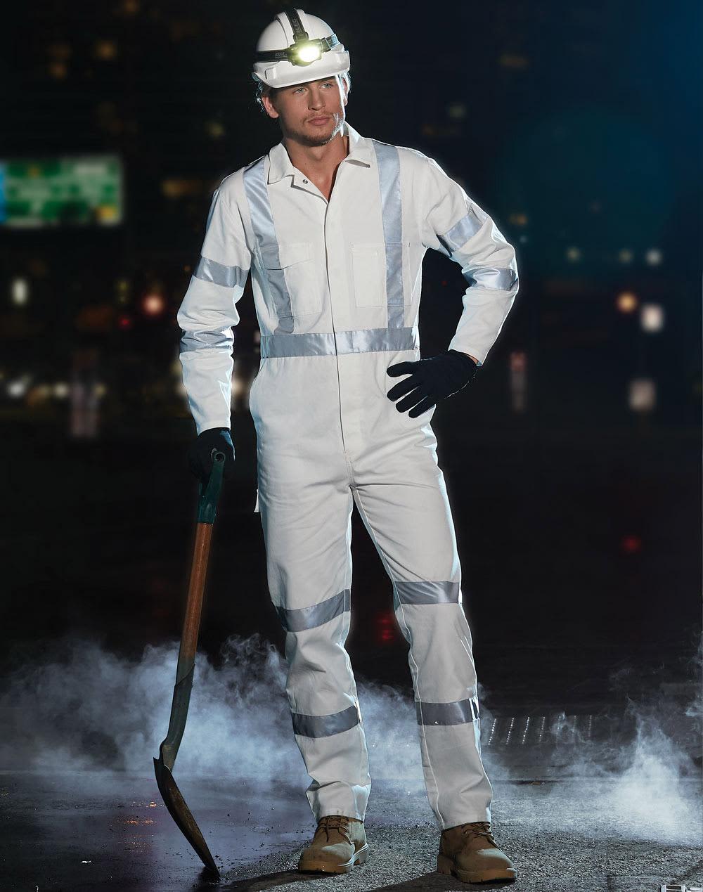 A white coverall with reflective strips, worn with gloves and a helmet, featuring a shovel in a smoky environment. Biomotion Night Safety Coverall - Image 1