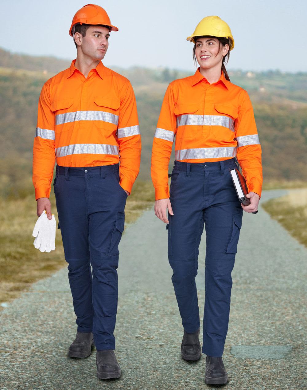 Two individuals wear unisex cotton stretch ripstop work pants in navy, paired with bright orange shirts and hard hats. Unisex Cotton Stretch Ripstop Work Pants - Image 1