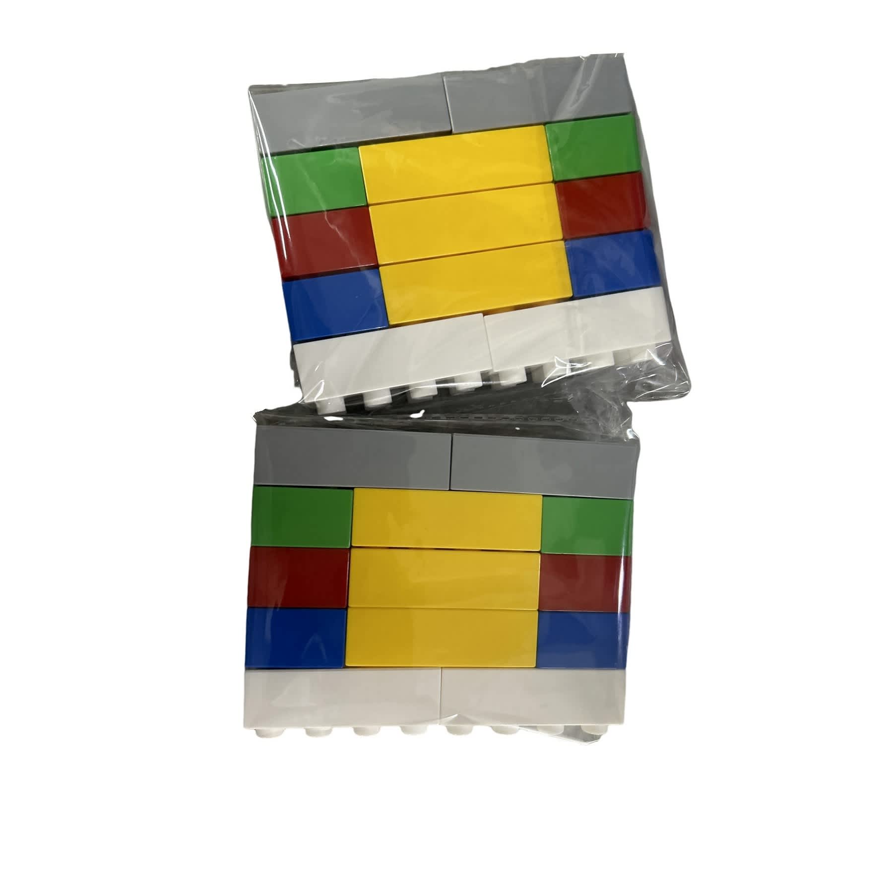 Two packs of building block toys in grey, yellow, green, red, and blue colours. Each pack is wrapped in clear plastic. Building Block Toy - Image 1
