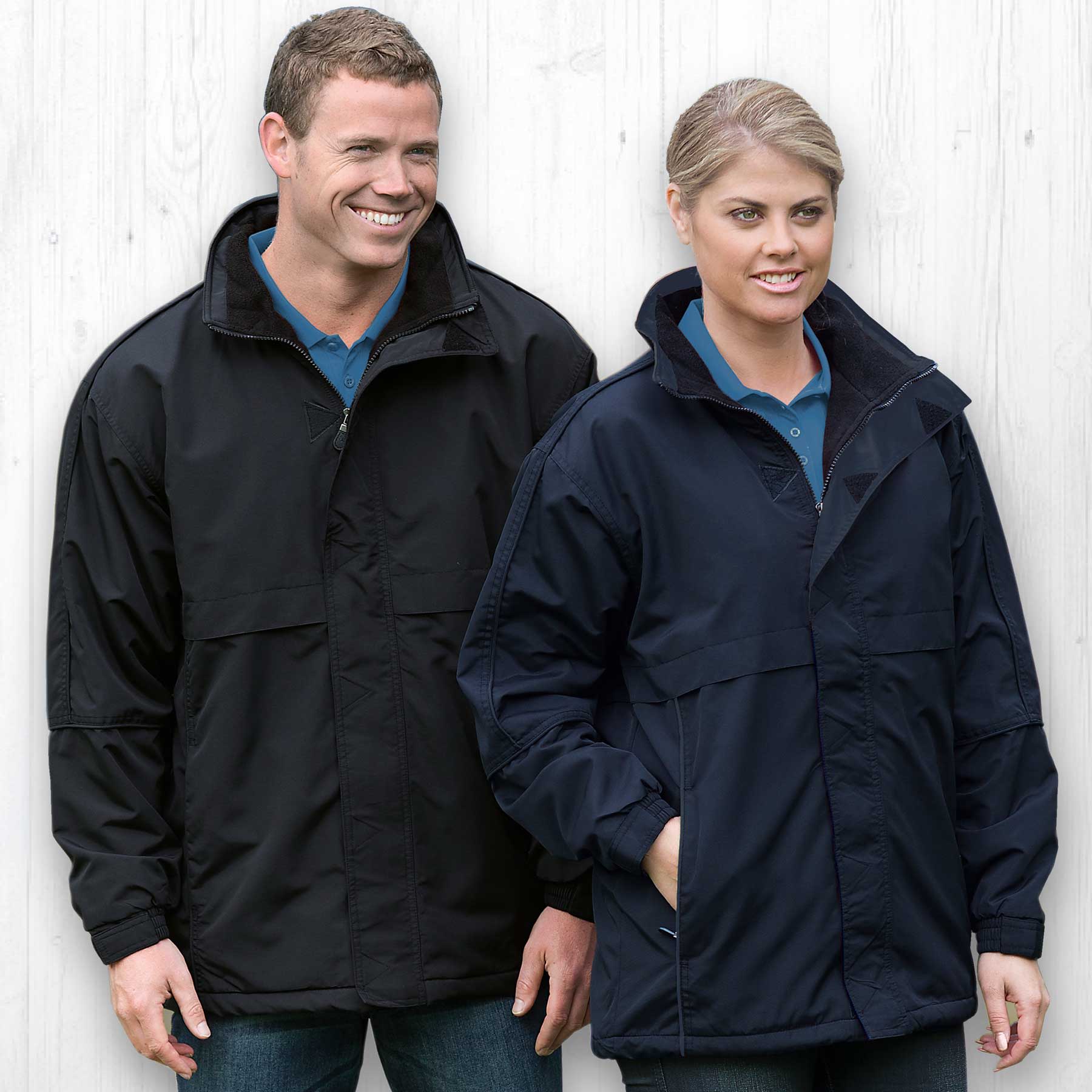 A black and a navy rain jacket displayed on two models, featuring a logo on each jacket. Plain Basecamp Anorak - Image 1