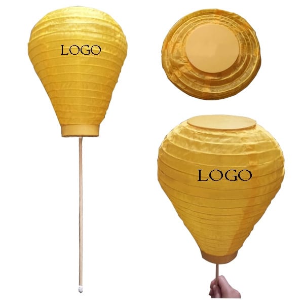 A foldable LED lantern in vibrant yellow, featuring a stick for support and a logo on the surface. Foldable LED Lantern - Image 1