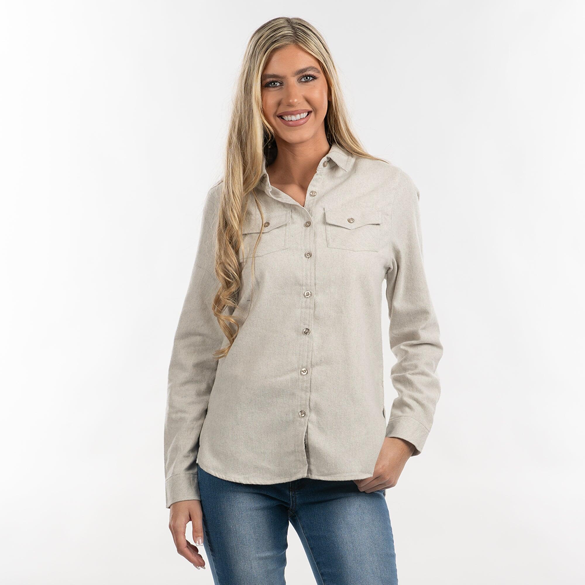 A light beige button-up flannel shirt with two chest pockets, worn by a smiling woman. The shirt features a logo. Extra Soft Solid Flannel Shirt - Image 1