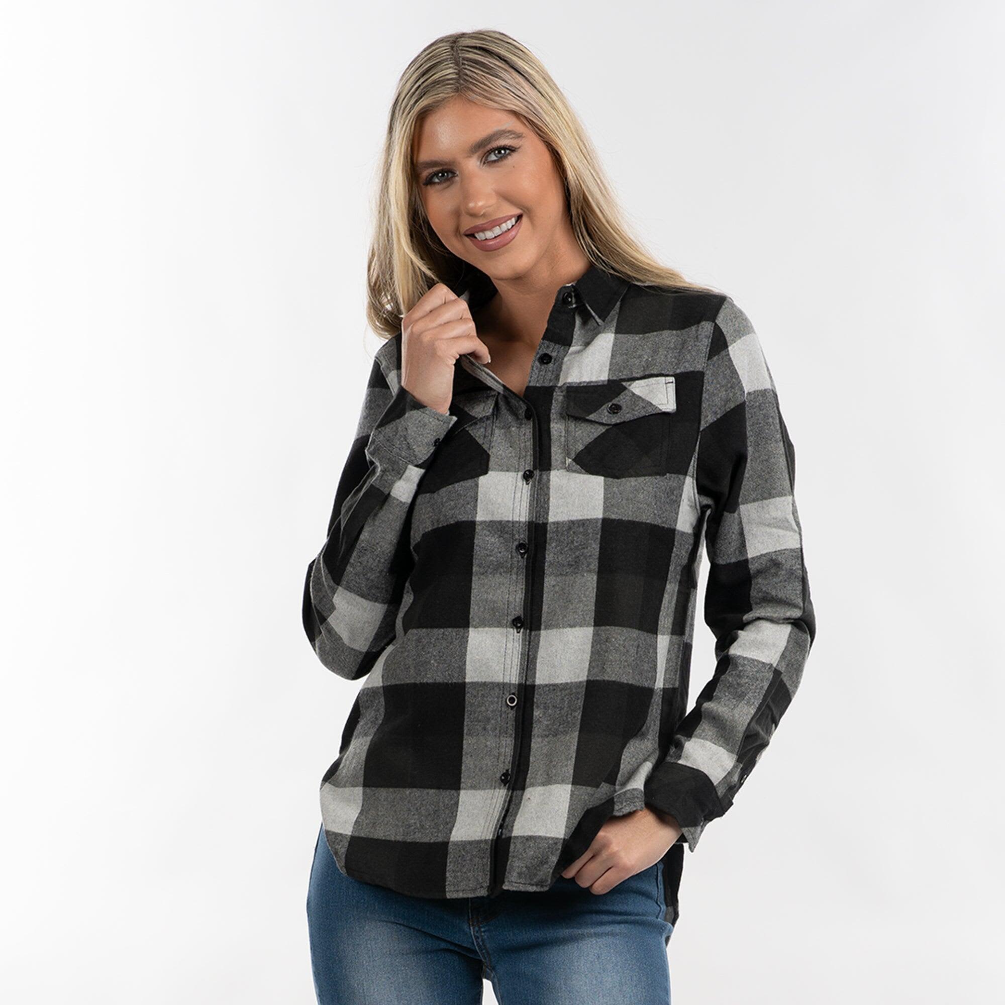 A woman wearing a black and white checkered flannel shirt with button-up front and pockets, smiling at the camera. The Boyfriend Flannel Shirt - Image 1