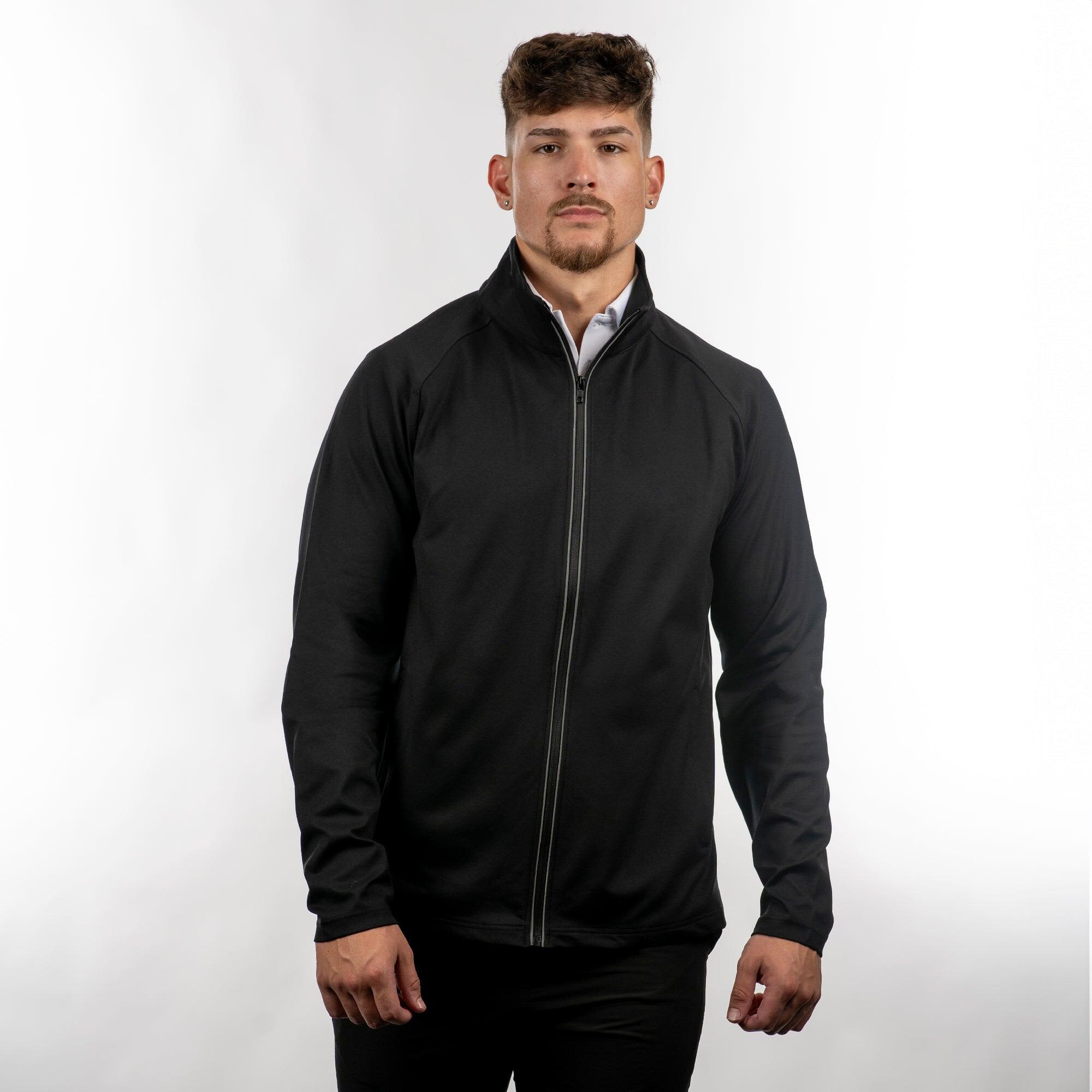 A man wearing a black full zip jacket, standing against a light background. The jacket features a logo. The Burn Full Zip Jacket - Image 1