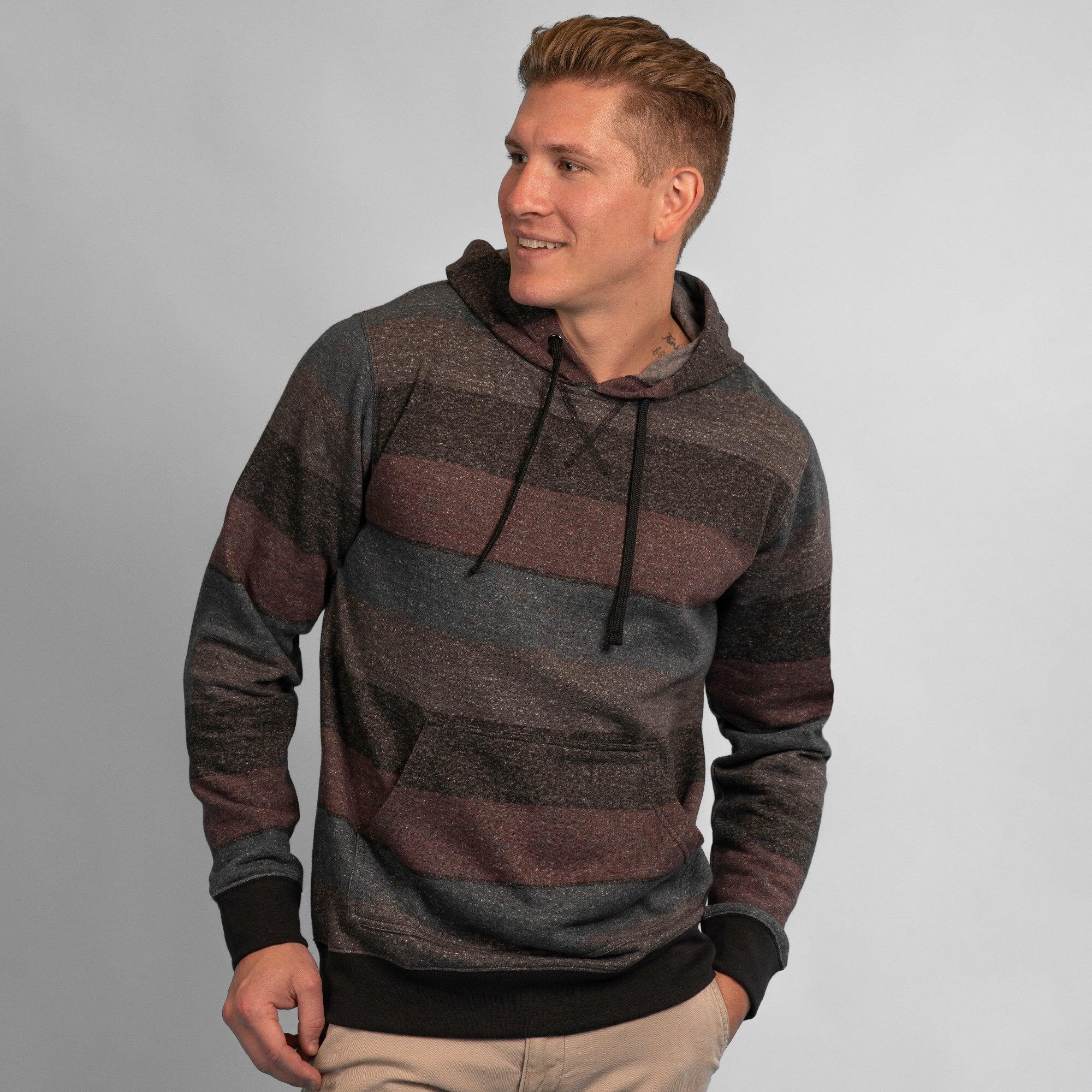A fleece pullover in dark grey, maroon, and blue stripes with a hood, featuring a logo. Fleece Pullover - Image 1