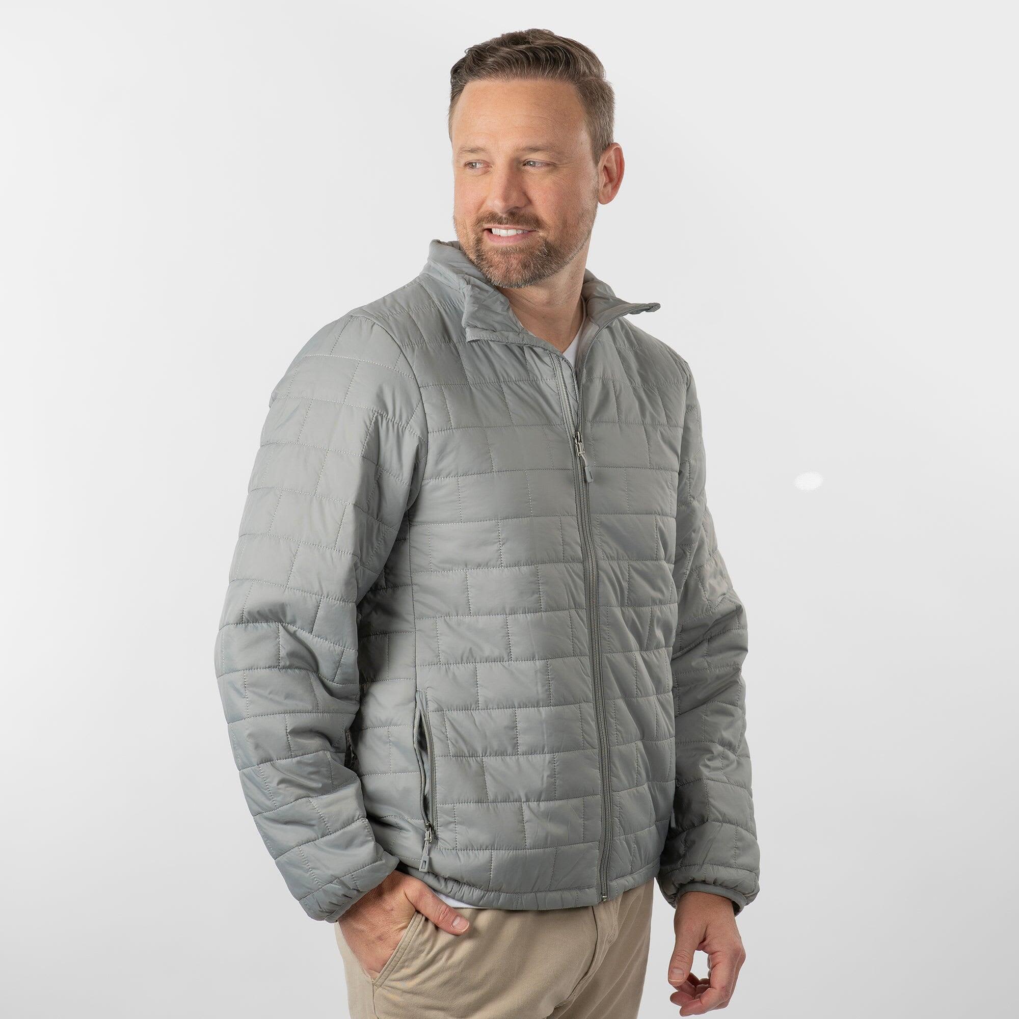 A grey quilted puffer jacket with a zip front and side pockets, worn by a model against a neutral background. Quilted Puffer Jacket - Image 1