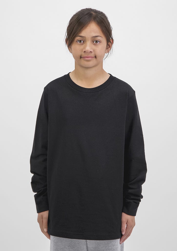 A black long sleeve tee for kids displayed on a model with a neutral background. Kids Basis Long Sleeve Tee - Image 1