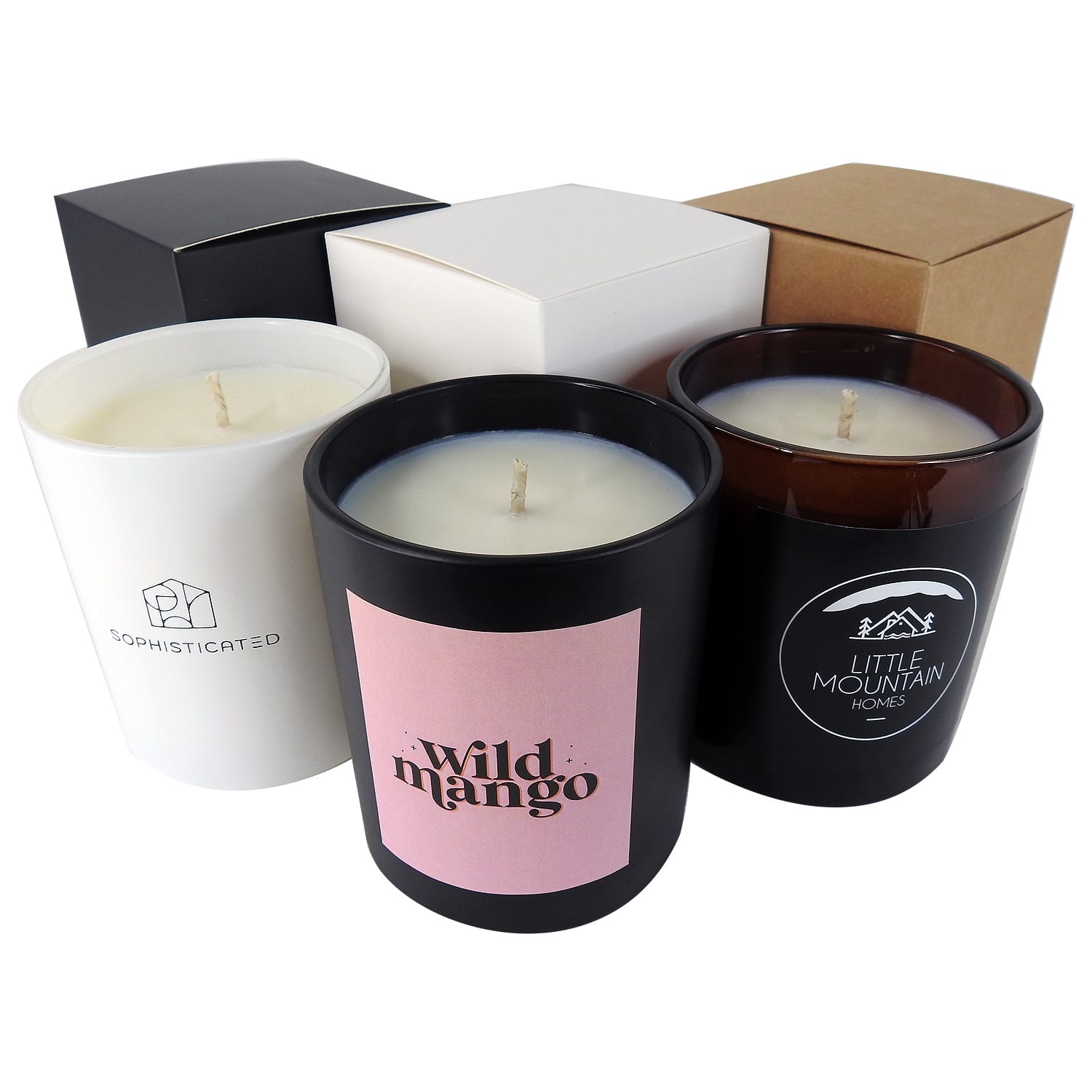 Three candles in various coloured containers: black, white, and brown, with different label designs, beside assorted boxes. Large Candle 300g - Image 1