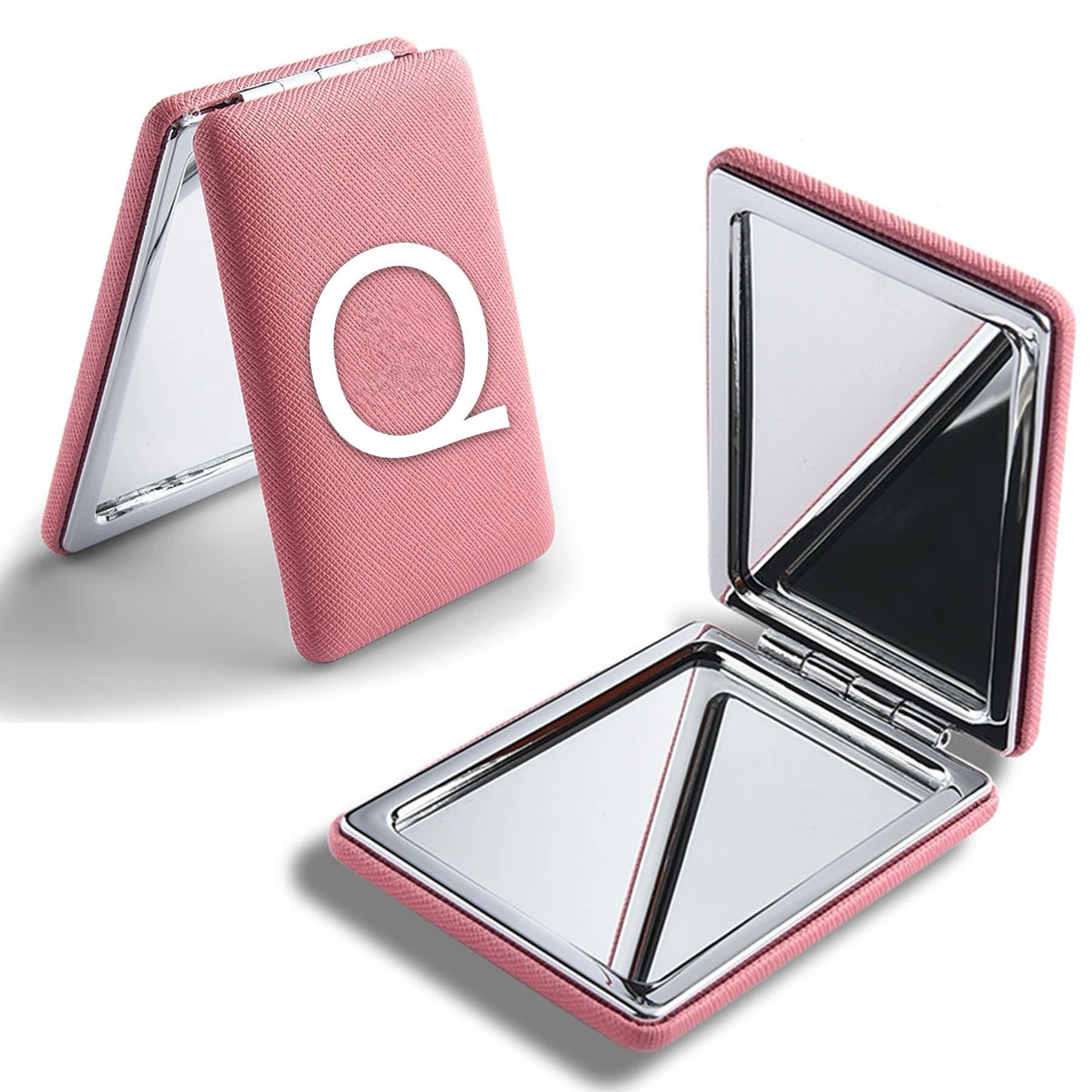 A pink portable mirror with a textured exterior and a logo, featuring two reflective surfaces inside. Portable Mirror - Image 1