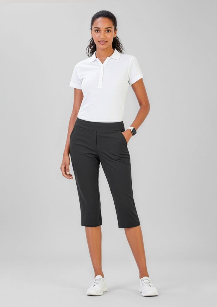A pair of women's black 3/4 length stretch pants displayed on a model wearing a white polo shirt. Womens Jane 3/4 Length Stretch Pant - Image 1