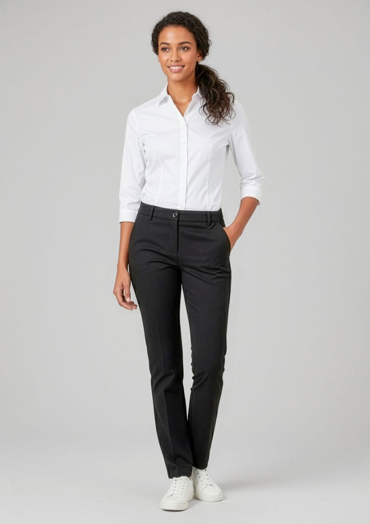 A woman in a fitted white shirt and black straight-leg pants stands smiling with a hand in her pocket. Womens Comfort Waist Straight Leg Pant - Image 1