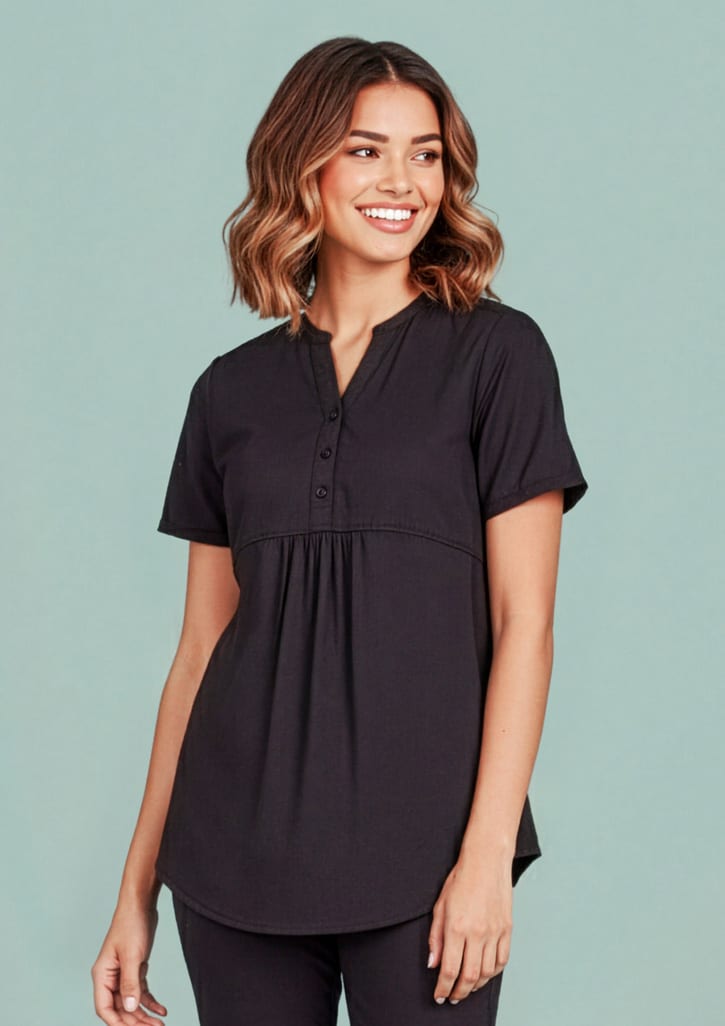 A women's black tunic scrub top featuring a buttoned neckline and a relaxed fit. The top has a logo on it. Womens Rose Tunic Scrub Top - Image 1