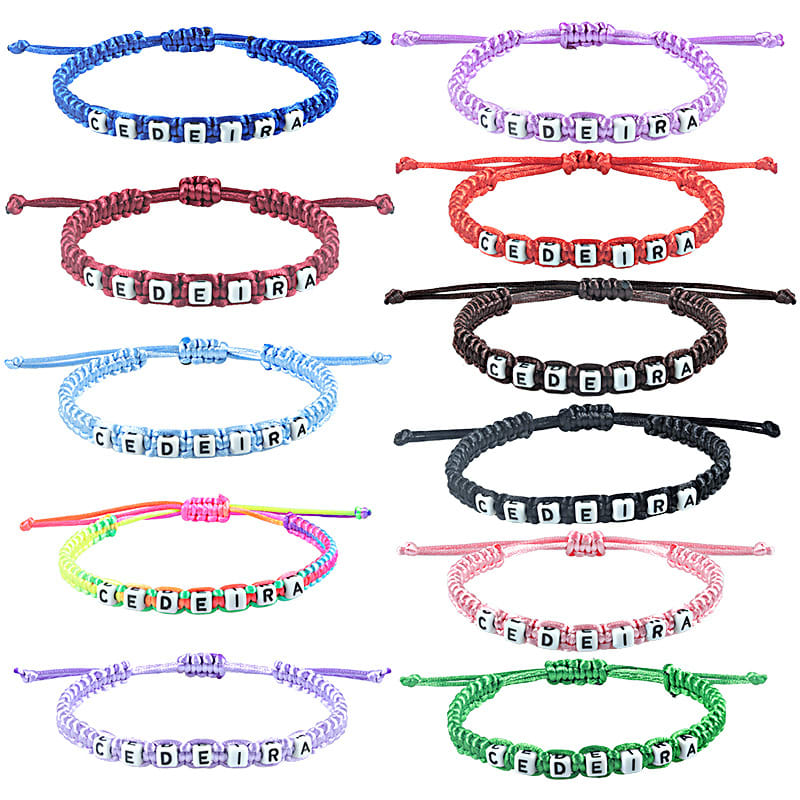 A selection of colourful friendship string wristbands featuring bead letters, including red, blue, pink, green, and black variations. Friendship String Wristband - Image 1