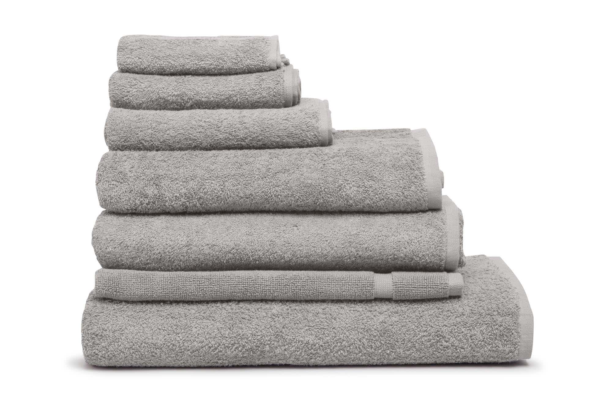 A stack of grey towels of various sizes, featuring a soft, plush texture and a simple design. Elite Small Hand Towel 500 gsm Silver - Image 1