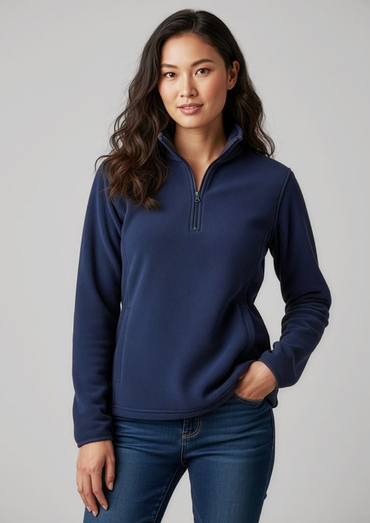 A navy polar fleece jacket featuring a half-zip design, modelled by a woman with long hair. Includes a logo. Womens Trinity Fleece - Image 1