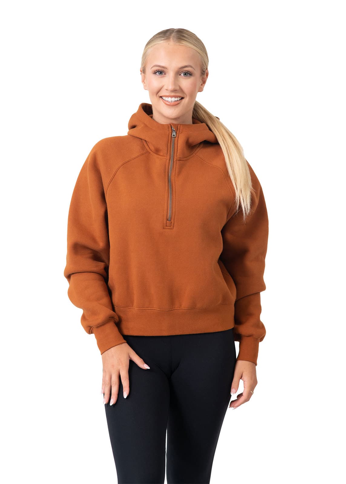 A woman wearing an orange-brown half-zip jumper with a hood, posing against a white background. Womens/Girls Cotton Care Half-Zip - Image 1