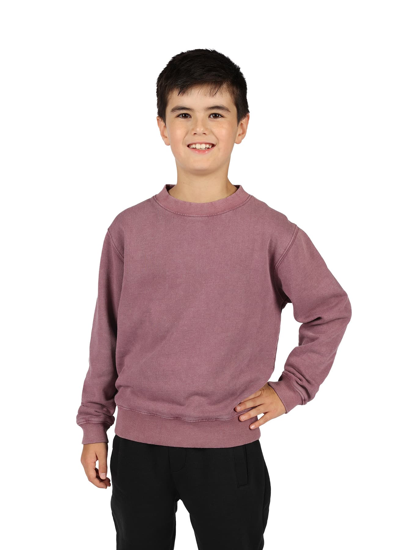 A unisex stone wash sweatshirt in a muted mauve colour, worn by a smiling child with dark hair, standing in a casual pose. Unisex Stone Wash Sweatshirts - Image 1