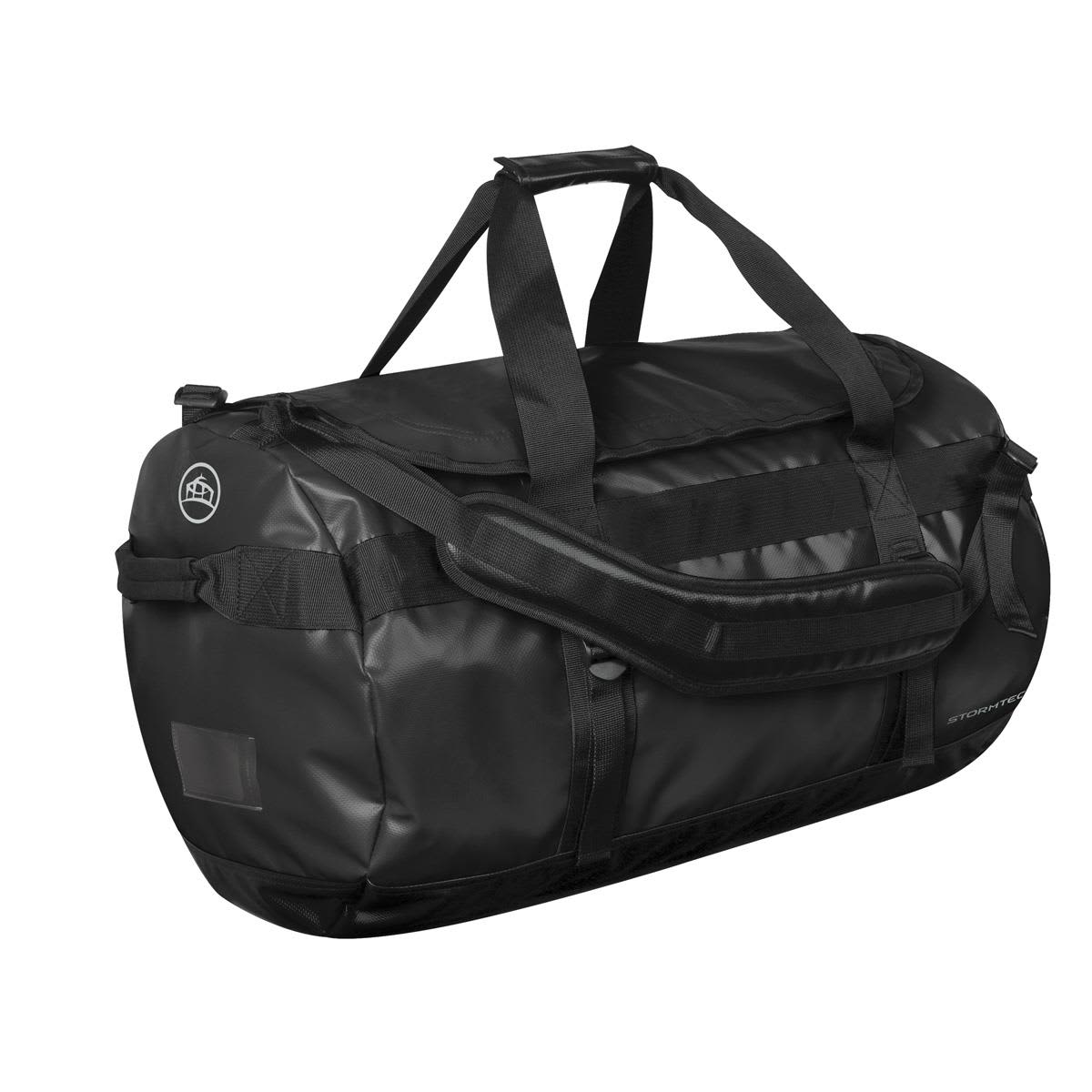 A medium black duffle bag with handles and a shoulder strap, featuring a logo on one side. Stormtech Gear Bag Medium - Image 1