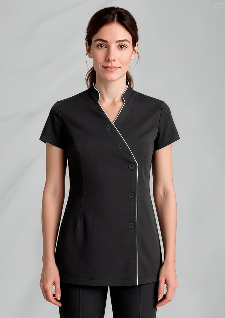 A black women's crossover tunic with short sleeves and white piping details, featuring a button closure. Womens Zen Tunic - Image 1
