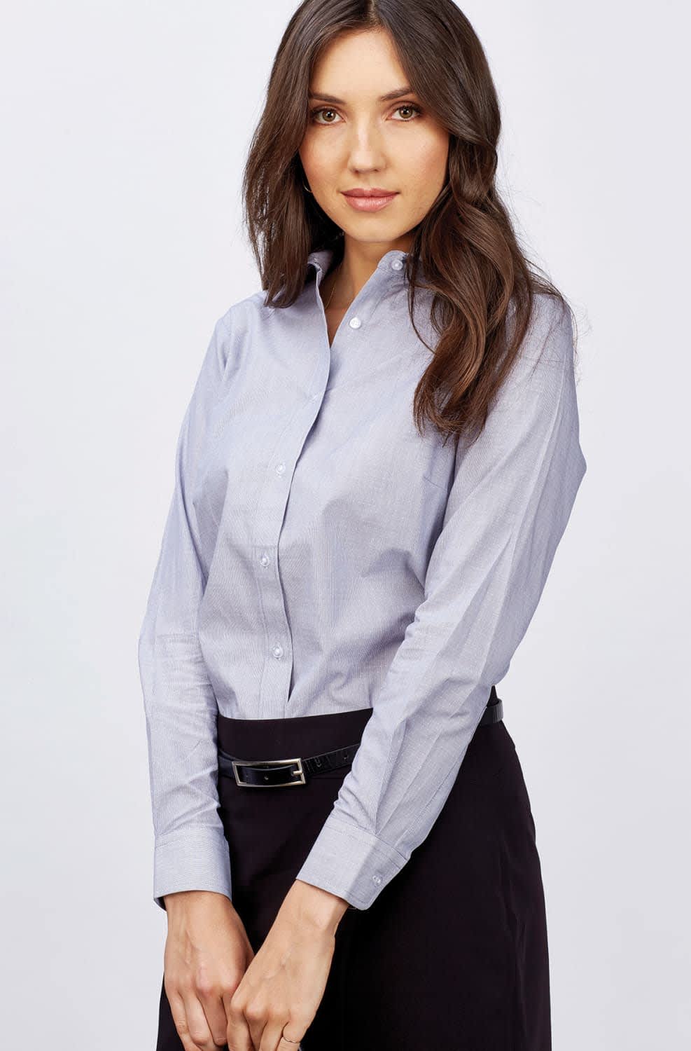 A button-up shirt in light blue, featuring long sleeves and a collar, worn by a woman with long hair. Hunter - Ladies Long Sleeve Shirt - Image 1