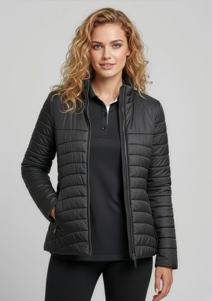 A women's puffer jacket in dark grey, featuring a fitted design and zip pockets, with a model wearing it. Womens Expedition Jacket - Image 1