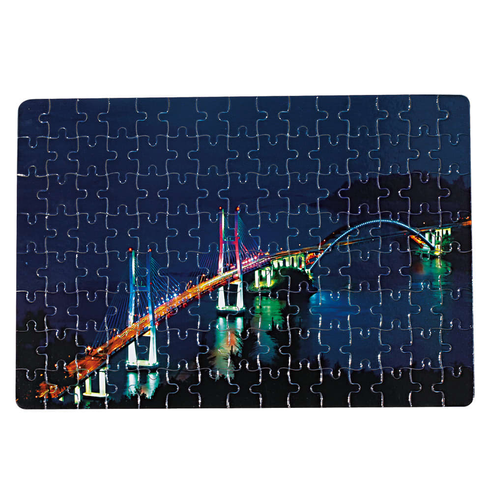 A jigsaw puzzle featuring a brightly lit bridge at night, with various blue and green tones. It has a logo on the corner. Fairy Jigsaw puzzle - Image 1