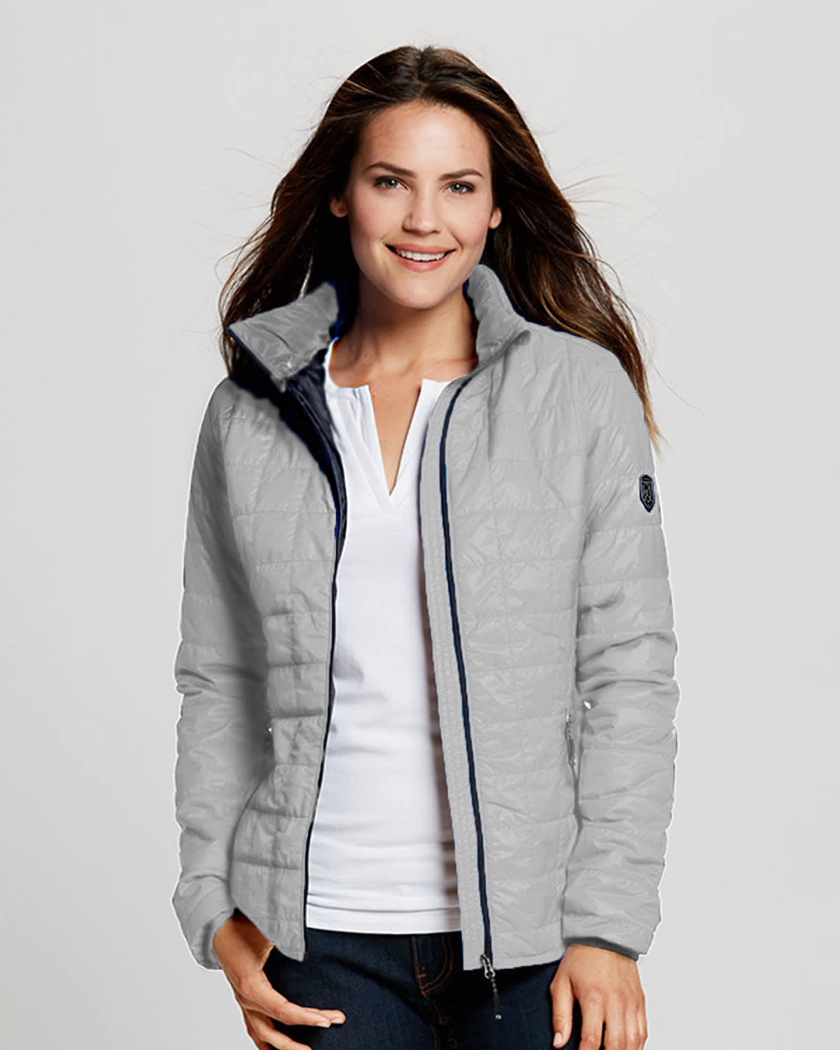 A lightweight, grey rain jacket with a zip front and high collar, featuring a simple logo on the sleeve. CB WeatherTec Ladies Rainier Jacket - Image 1