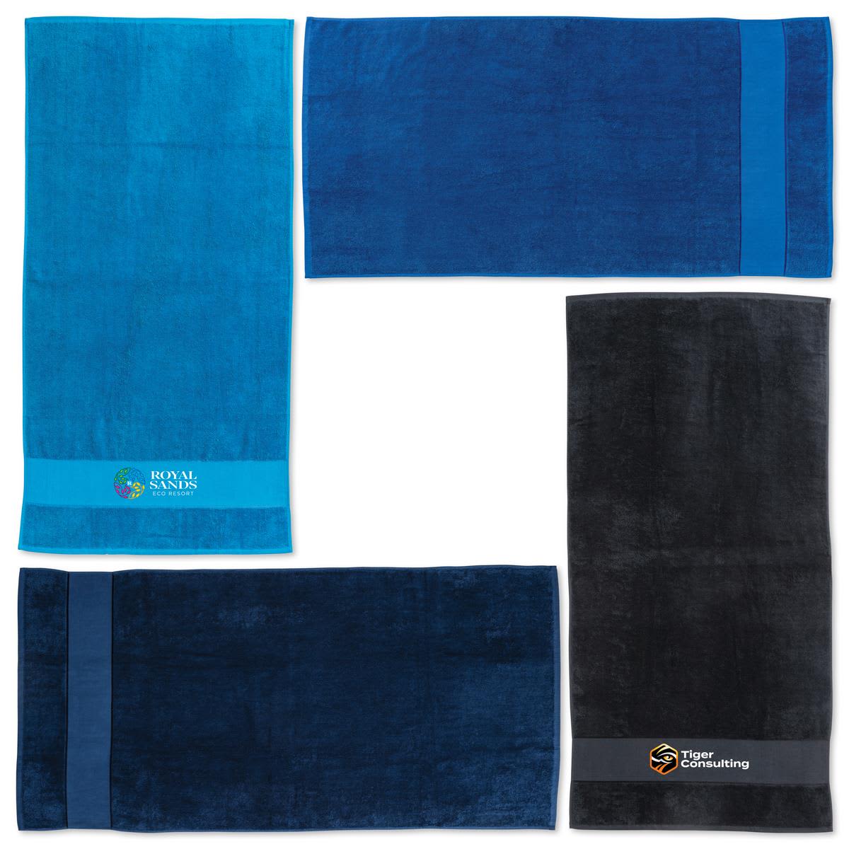 A set of four beach towels in shades of blue and black, featuring logos and branding on some. Bondi Beach Towel - Image 1