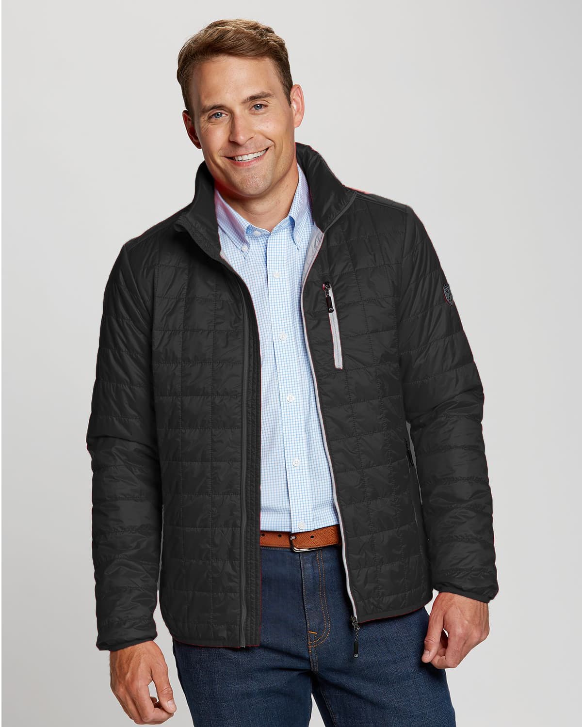 A man wearing a black weather-resistant jacket with a zippered front and a collar, featuring a small logo. CB Men's WeatherTec Rainier Jacket - Image 1