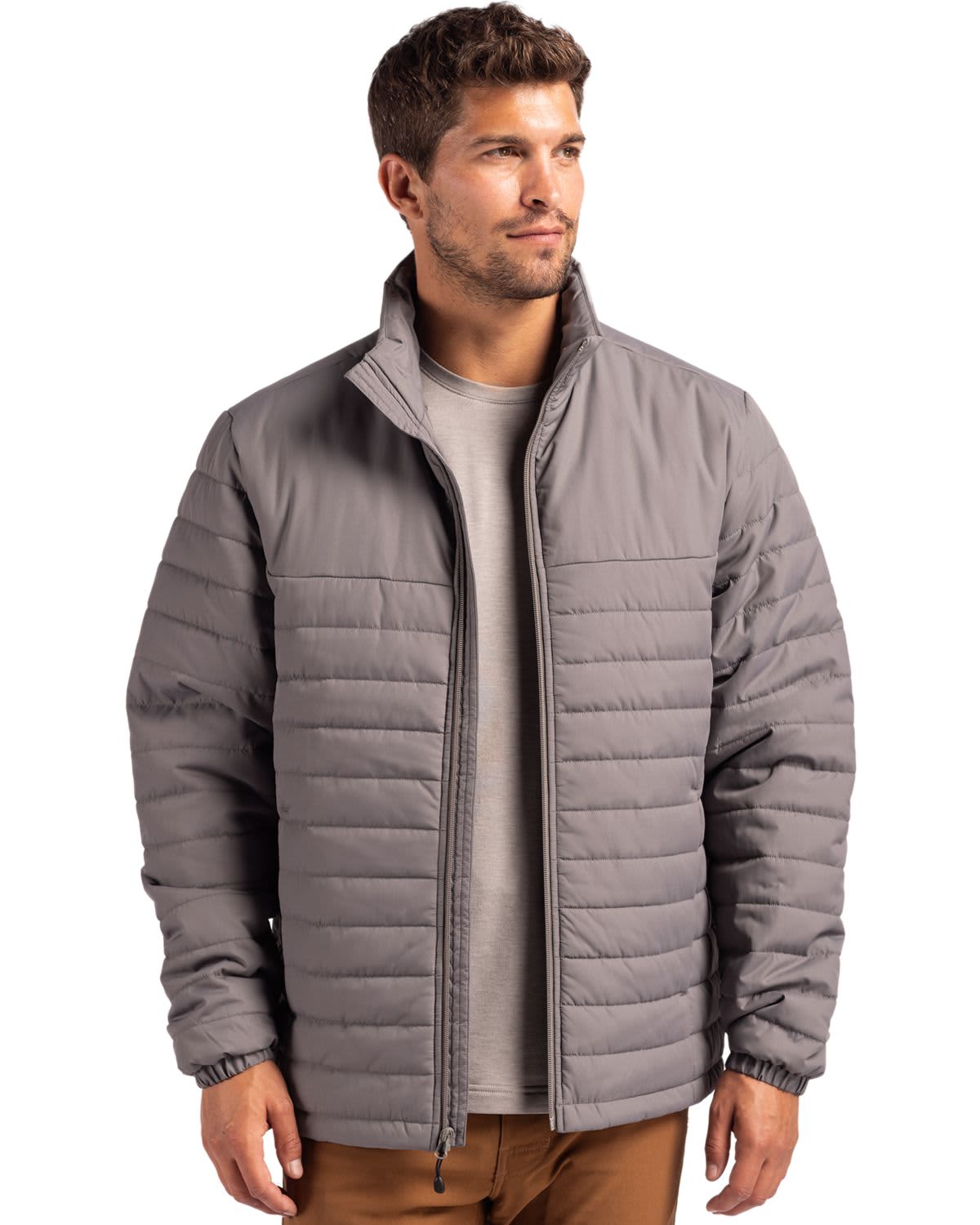 A man wearing a grey puffer jacket with a zip front and standing against a plain background. Men’s Elevation Eco Puffer Jacket - Image 1