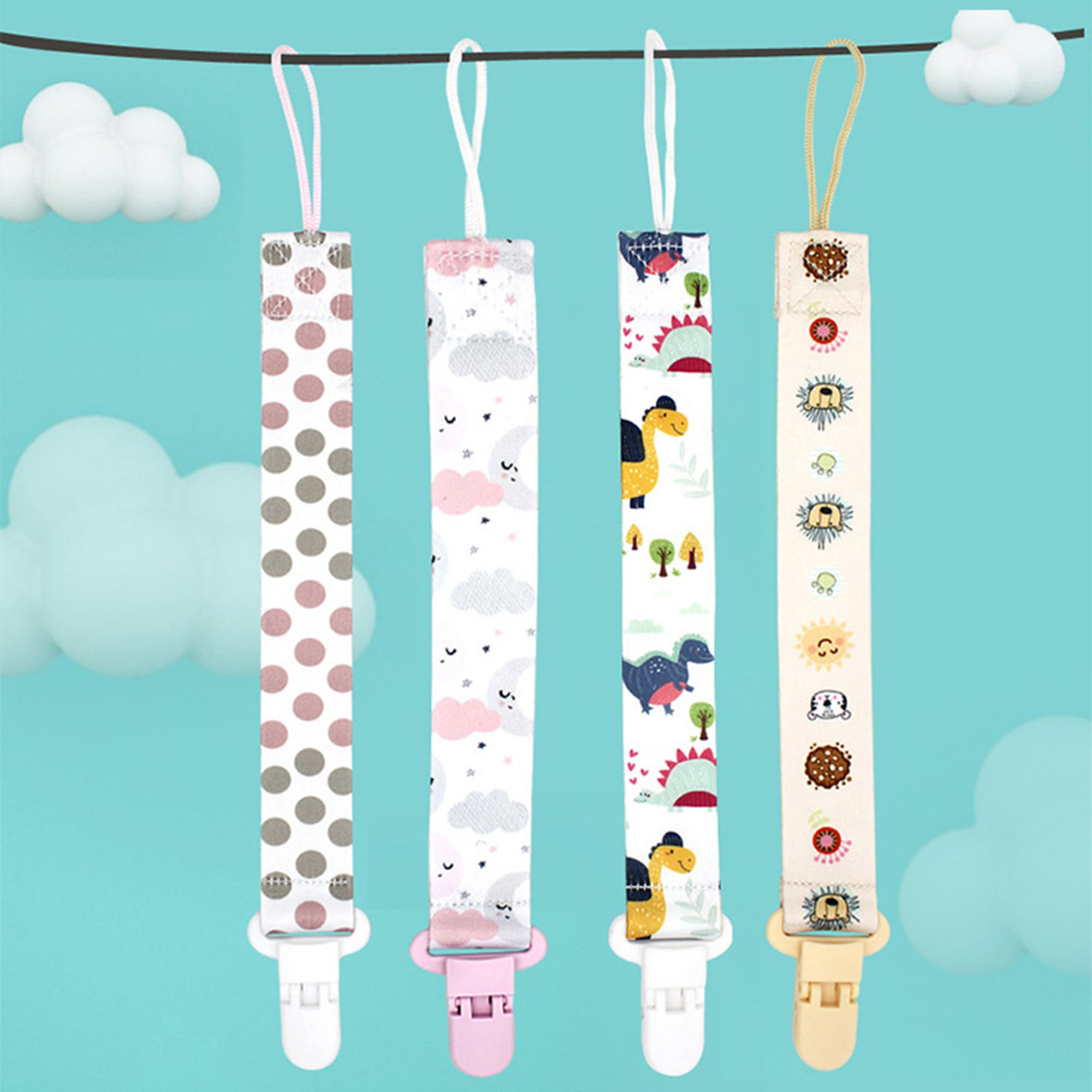 A baby pacifier chain holder set with four colourful designs featuring polka dots, clouds, dinosaurs, and sun motifs. Baby Pacifier Chain Holder - Image 1