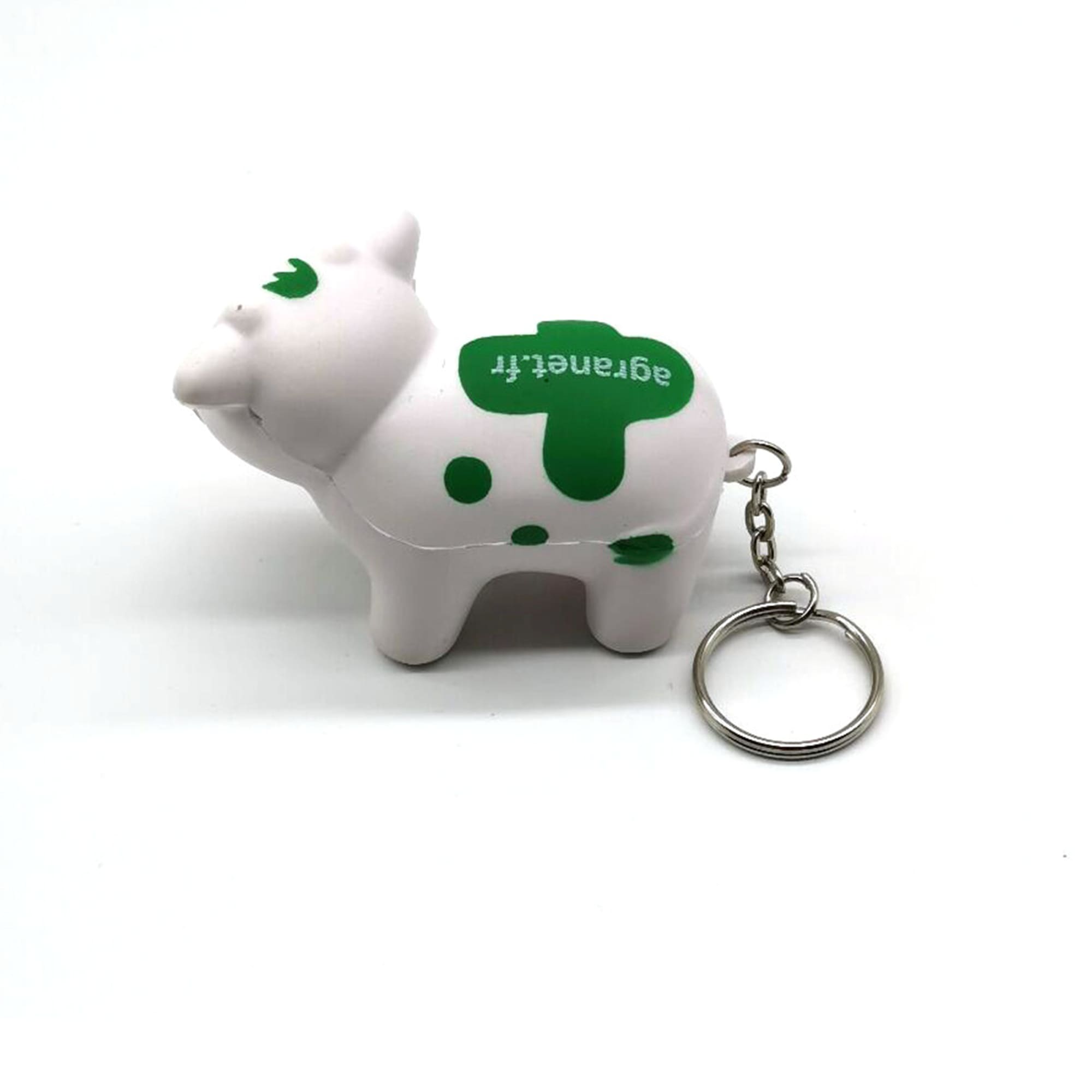 A white and green milk cow stress key chain with a keyring attached. Milk Cow Stress Key Chain - Image 1