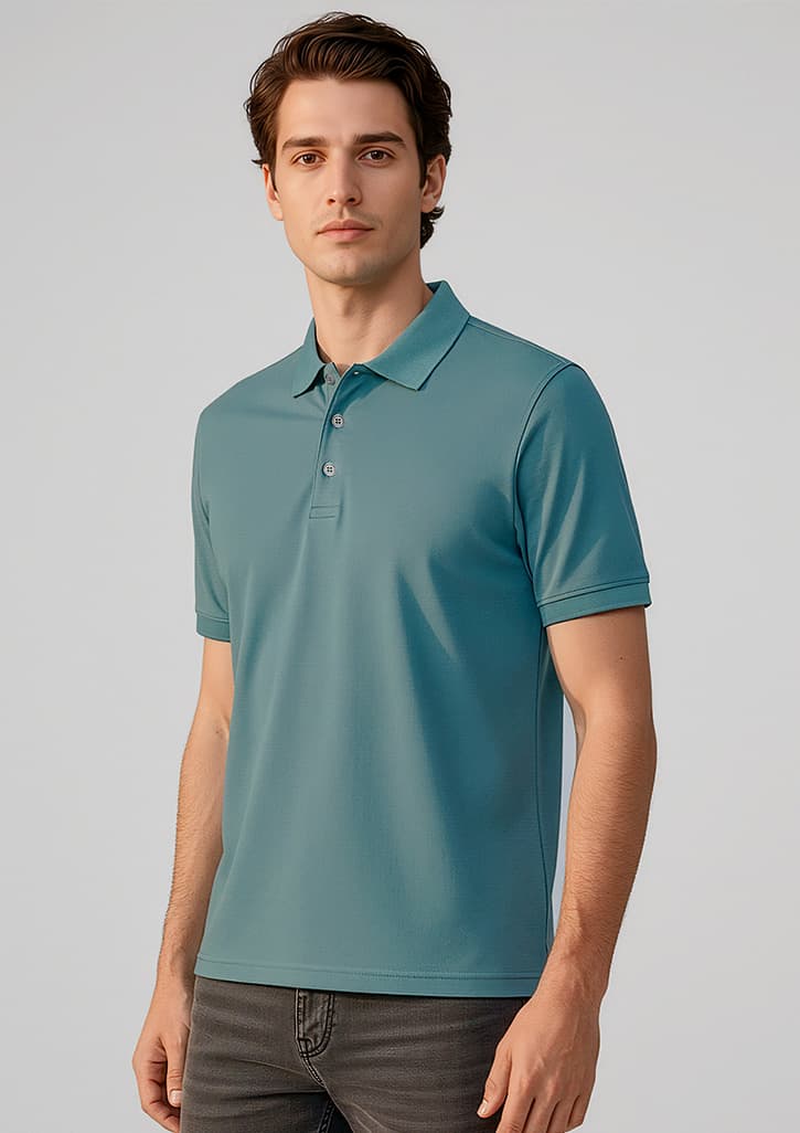 A men's short sleeve polo in teal, featuring a collar and buttons, modelled by a man. It has a logo. Mens City Short Sleeve Polo - Image 1