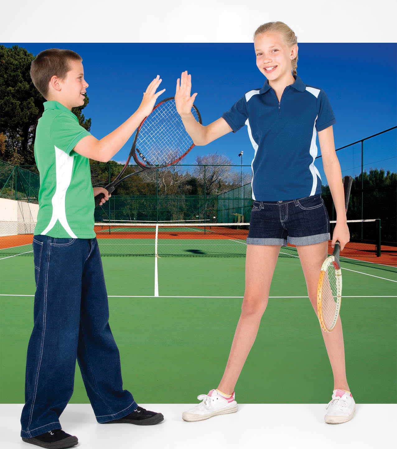 A boy in a green polo shirt and a girl in a blue polo shirt, both holding tennis rackets on a court. Cool Best Polo - Image 1